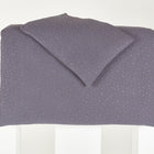 Das KraftKids Bettwäscheset Musselin in Grau mit goldenen Punkten ist ordentlich gefaltet und auf einer weißen Fläche vor schlichtem Hintergrund präsentiert.